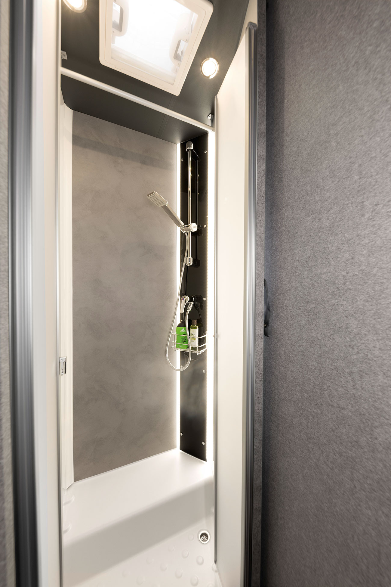 The shower combines plenty of elbow room with an elegant design. The backlit shower equipment is part of the Light Moments ambient lighting system.